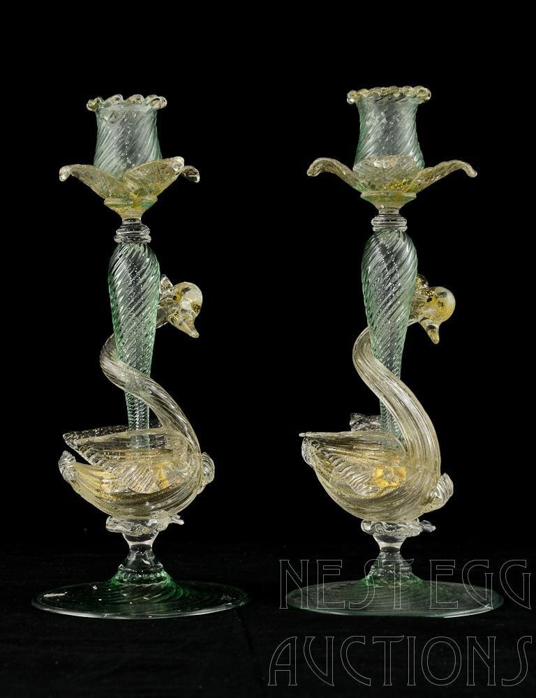 Pair of Murano Vennini Glass Swan Form Candlesticks: This beautiful pair of Venetian Art Glass Candlsticks are expertly crafted with many pieces of applied gold-infused glass. 10.5" Tall. Carefully inspected and free from damage or repairs. most likely 