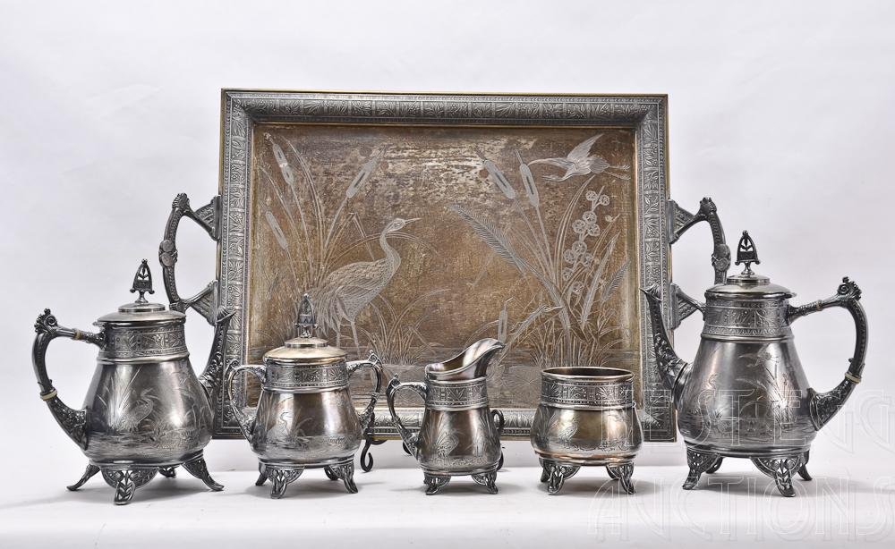 6 pc. Victorian Silverplate Tea Service: Pairpoint Manufacturing Co. Quadruple Plate, all pieces marked "300" Tray Measures 26" x 16" all pieces in good condition, some plate loss. depicts a marsh scene with Egrets, cattails and other flora 