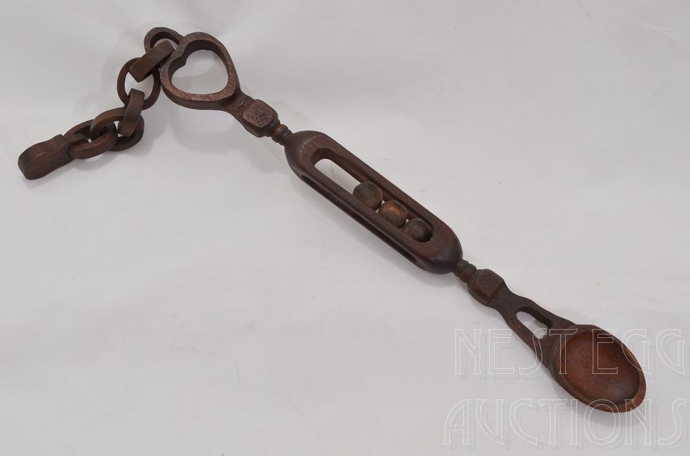 Carved Tramp or Hobo Folk Art Captive Ball Spoon: Mahogany or Walnut spoon with three captive or caged balls, a heart linked by five pieces of chain to a lock. 19.5" long. Excellent condition.