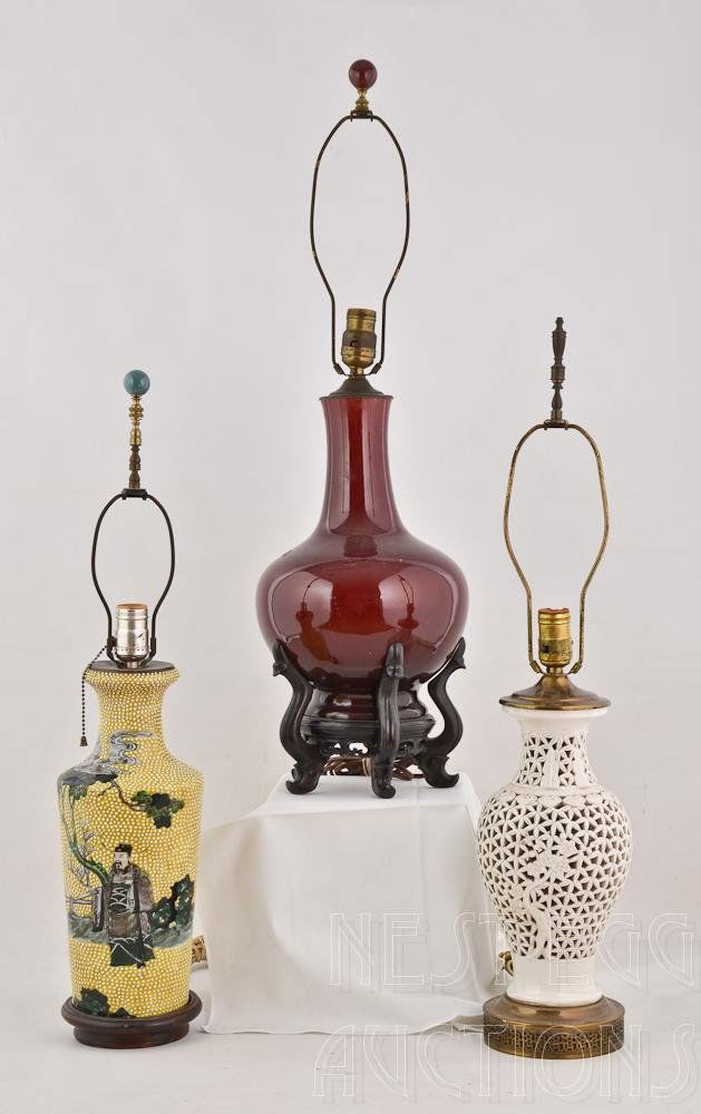 Three Chinese Porcelain Vases fitted as Lamps: The first being a Flambe or Oxblood Bottle Form Vase of excellent quality and age. Porcelain measures 13.5" tall, but has most likely been cut down from the top. The Second a Blanc De Chin White Open