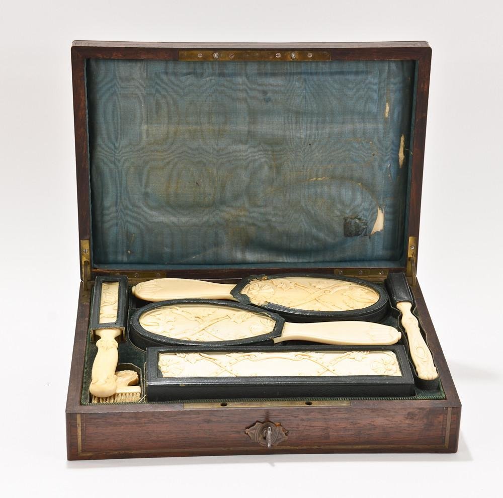 Carved ivory vanity travel brush set in fitted case: Very finely carved, natural ivory handles with natural bristles. Six brushes with handles in excellent condition, bristles show some bending and use, but are very complete and intact. Velvet lined cas