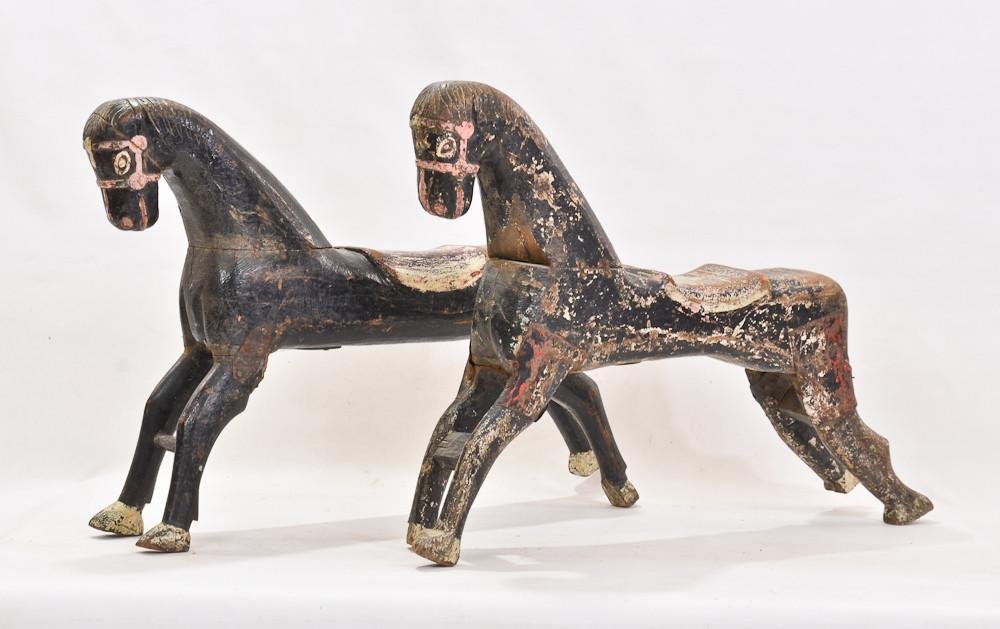 Two antique painted carousel horses: Smaller horses, possibly from Central or South America, Carved in a slightly naive folk art style, original old paint, repairs to legs, each measures approximately: 22" Tall, 33" Long and 7&