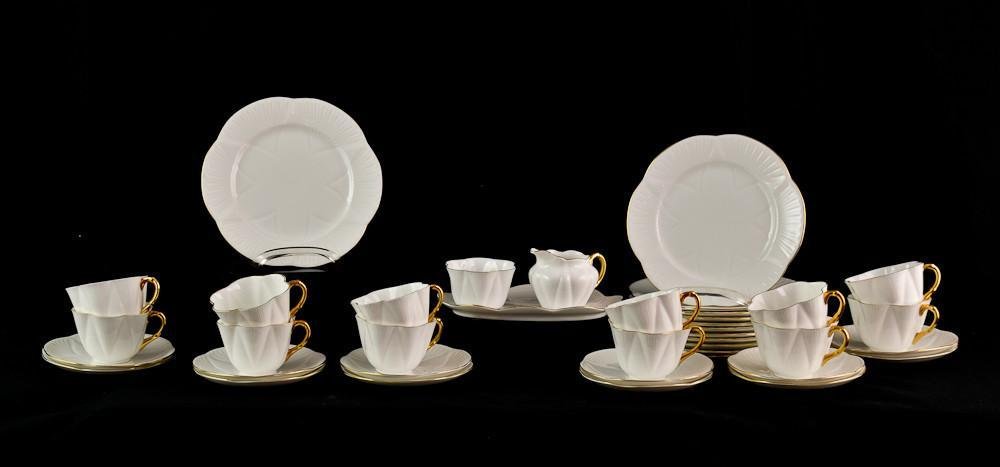 Shelley bone china luncheon set: Complete service for 12. White Seashell pattern, with green mark FINE BONE CHINA Shelley ENGLAND. includes Twelve 8" Luncheon Plates, Twelve teacups and saucers, plus Sugar and Creamer with under