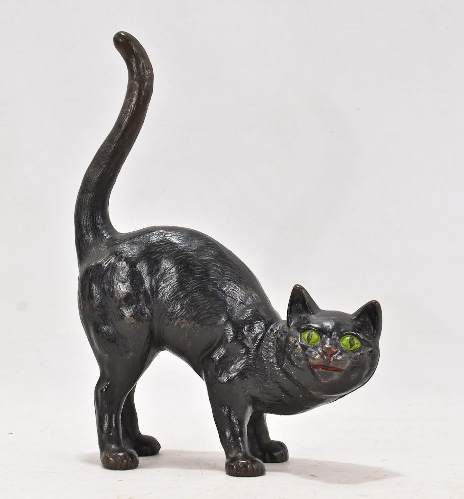Hubley black cat painted cast iron doorstop: With arched back and uplifted tail, 90-95% Paint retained, green eyes, 11" tall, 8" wide