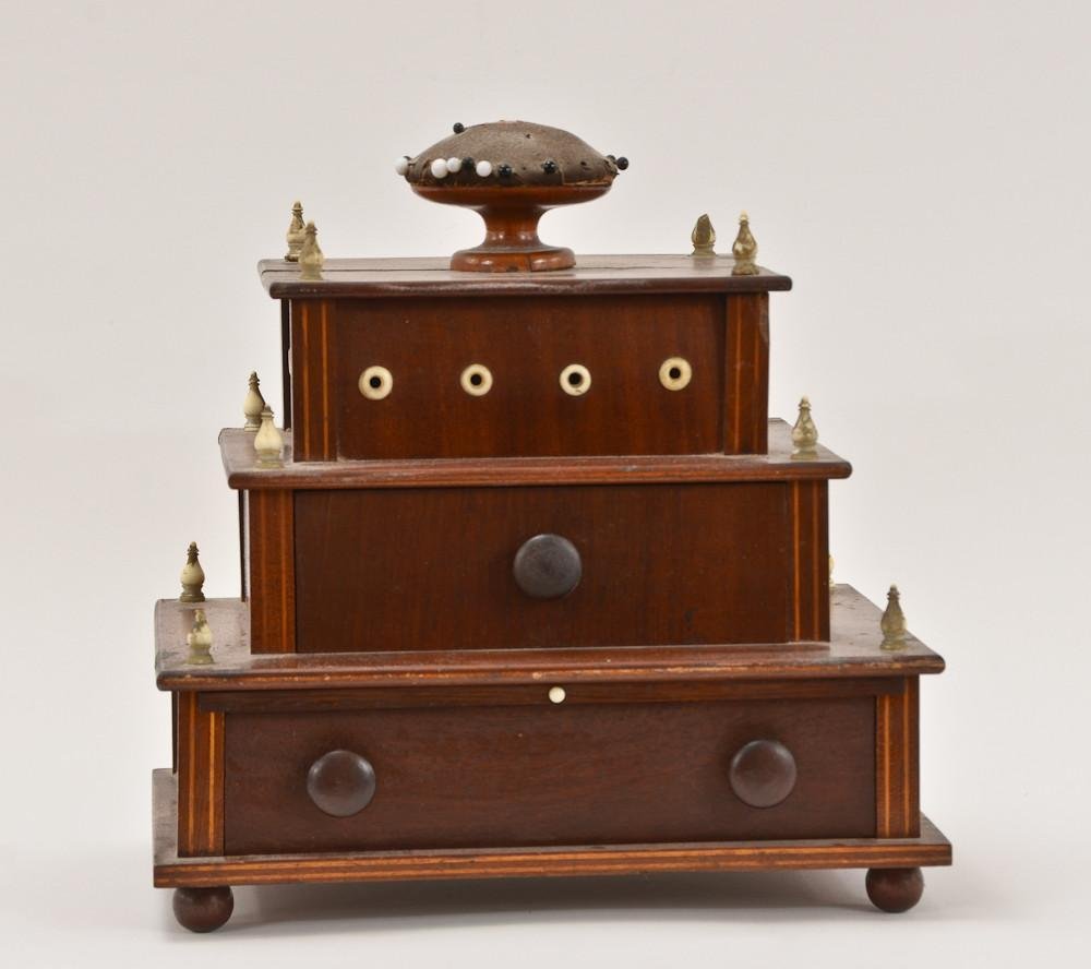 Three Tiered Ivory Mounted Sewing box: 19th C. American, 9" H x 9" W x 6" D nicely detailed with inlay, pull out flip-up mirror, and original contents: Leather needle cases, bit of embroidery work, scissors, etc. Top split,