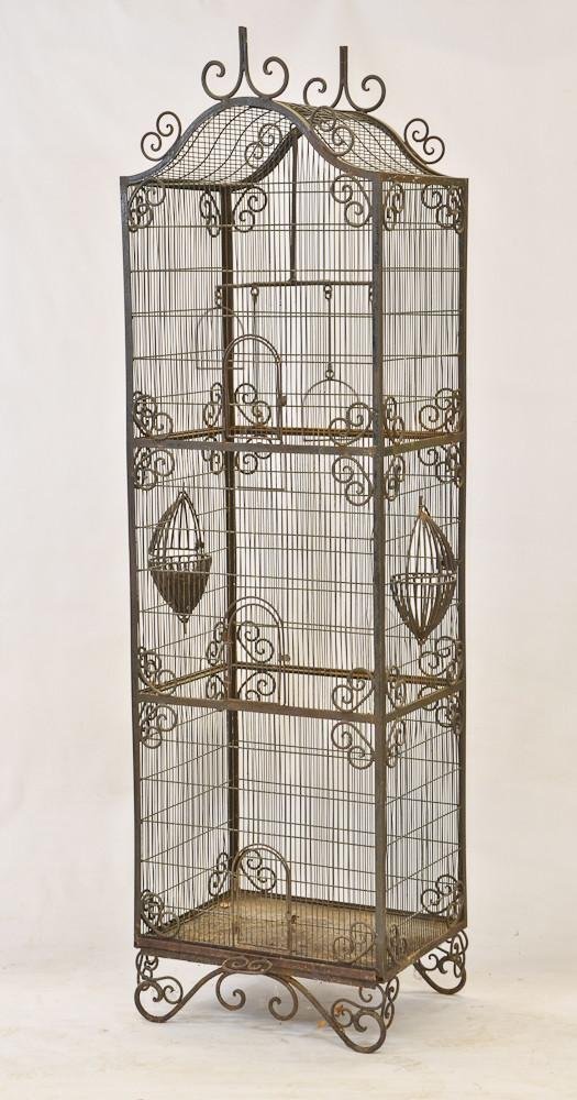 Freestanding Wrought Iron and wire birdcage: Floor model, late 19th or Early 20th Century very good condition, light surface rust throughout, 84" H x 24" W x 18" D