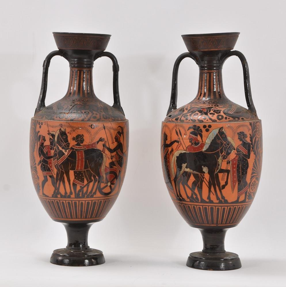 Pair of Greek Pottery Amphora Urns: This pair of Urns or Vases in terra cotta red clay with black glazed decoration most likely date to the 19th Century and would be considered Grand Tour pieces. This particular pair has been badly dama