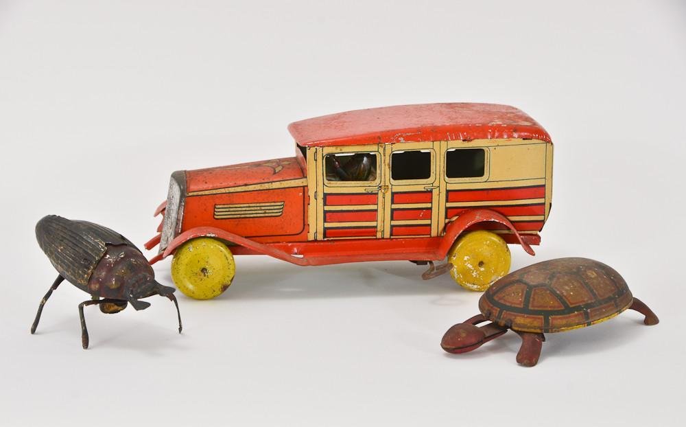 Group of 3 Mechanical Tin Toys: A clockwork Tin litho Juguetes Matarazzo Industria Argentina limousine with some paint loss, but in working condition 4" Tall, 9" Long, an unmarked clockwork walking turtle with some paint l