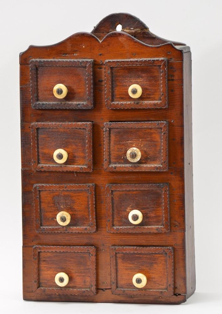 Tramp or Folk Art Carved American Spice Chest: Consisting of eight draws, with what appear to be bone pulls. early to mid 19th Century. Repair to top crest, otherwise very good, with original finish and strong patina. 14" H x 8.5" W x 4&