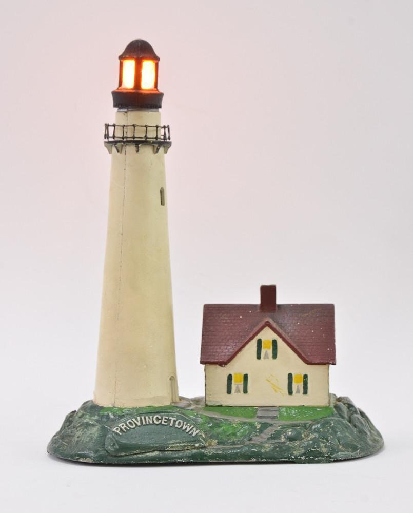 Provincetown MA cast metal lighthouse bank Lamp: An unusual item: Cast metal (most likely aluminum) Piggy Bank and Table Lamp combination. Hand Painted. marked R H Smith & Sons Taunton Mass. 20th Century. 12" tall, 9" wide. excellent w