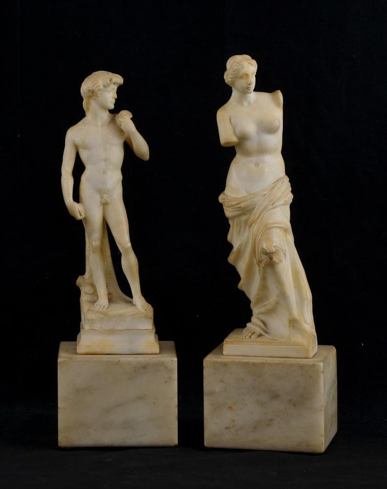 Pair of Italian Marble Grand Tour Statues: Venus DeMilo and Michelangelo's David. Each 13" Tall. The Venus does have chipping to her left knee. some age yellowing and dust present.