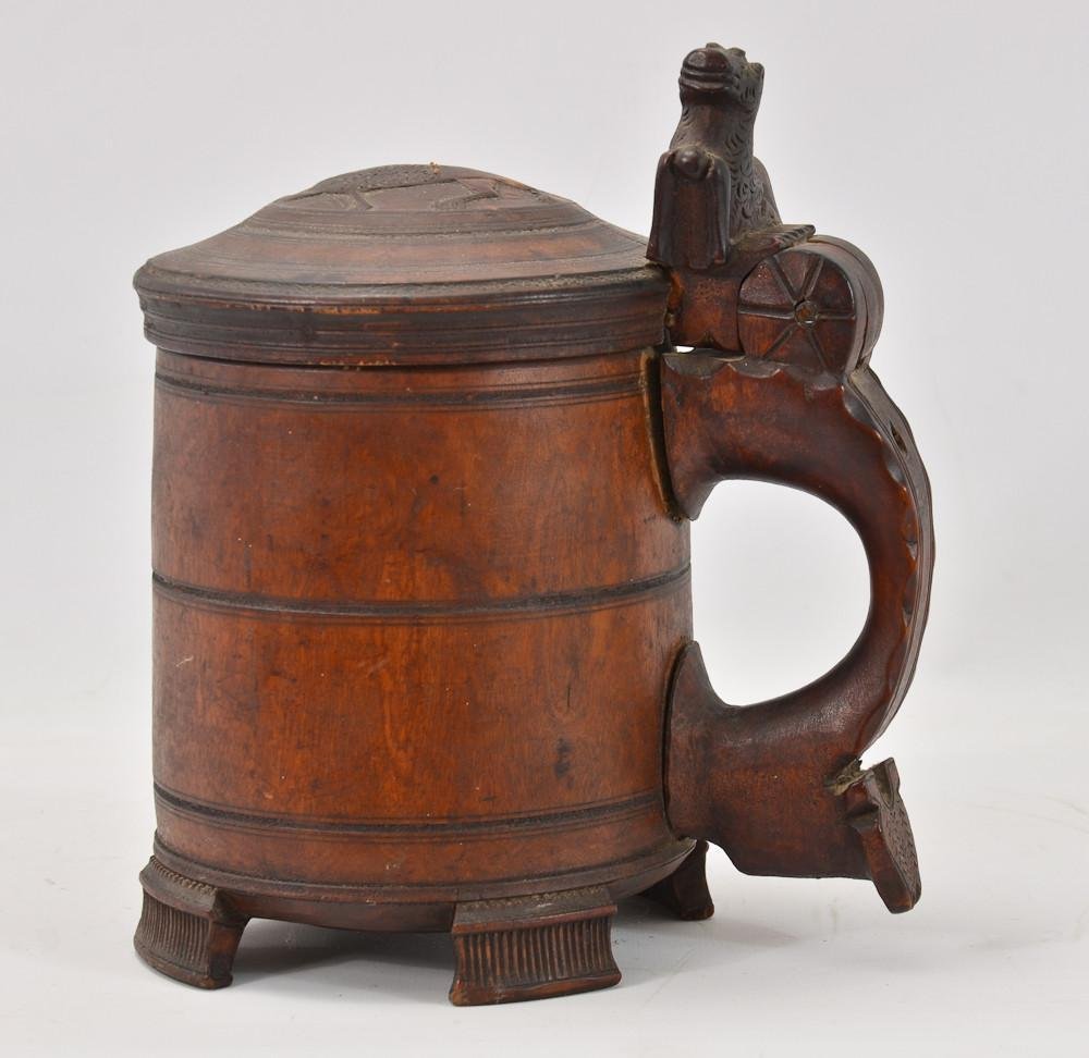 Scandinavian Carved Wood Beer stein: 18th Century, carved wooden stein with dragon or chimera cameo on lid, lion form thumb finial, with cylindrical turned body and bottom. pegged handle. 9.5" tall and 9" wide at the handle. Li