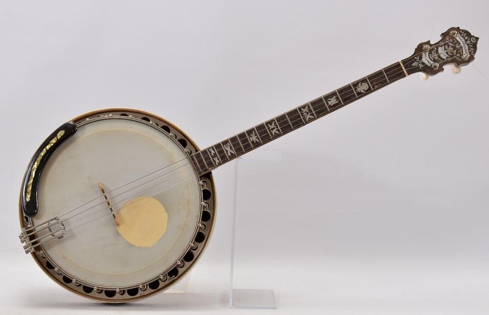 W.M. Lange Paramount Style C Tenor Banjo: With extensive Mother of Pearl inlay including dove fretboard inlay, carved neck heel, inlaid body and resonator. 35" x 15" Serial Number 6346. play wear to the back of neck and fretboard. m