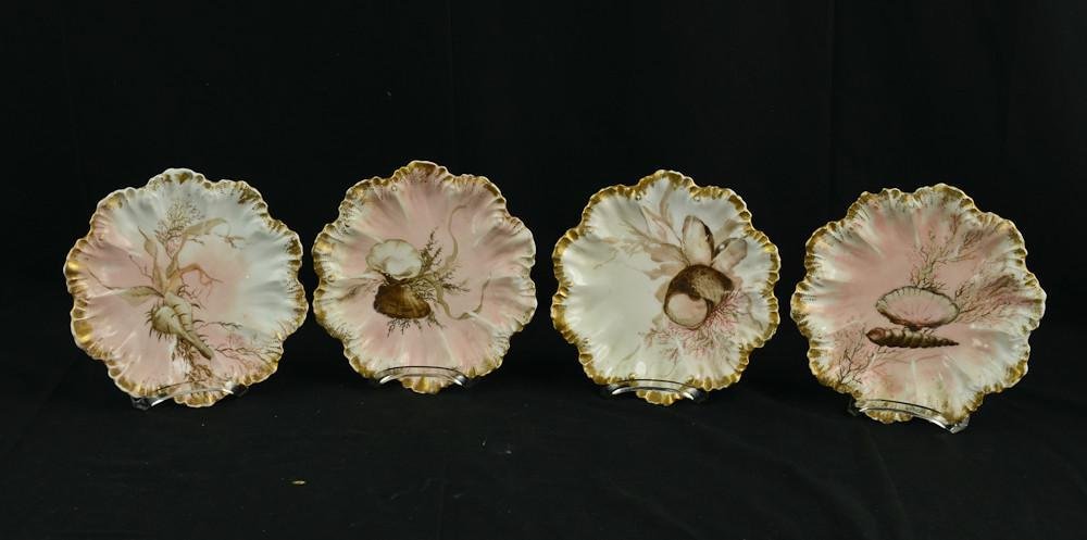 Four Hand Painted Limoges Porcelain Oyster Plates: Group of four hand painted French porcelain Oyster Plates. Made in France. Stamped Limoges, and marked Limoges with an Anchor and A. L. Depose. Each plate bears a different rendering