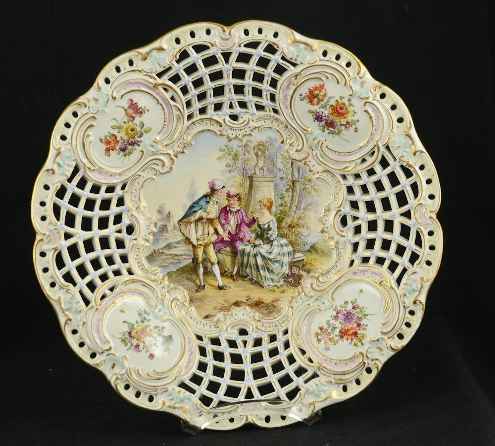German Porcelain Bowl: manner of Meissen: The pierced or reticulated open work dish bear an underglaze blue mark the appears to be a crossed sword with an "E" Large size, very fine, hand painted details with gilt and floral decorati
