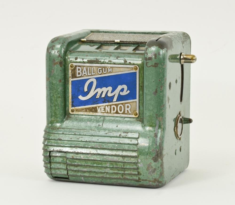 Imp Ball Gum Trade Stimulator slot Machine: Ball Gum Vendor, with three spinning reels that illustrate cigarette packs like Camel and Old Gold. Original painted green finish to metal case, some paint wear. This is a one cent or penny machine. K