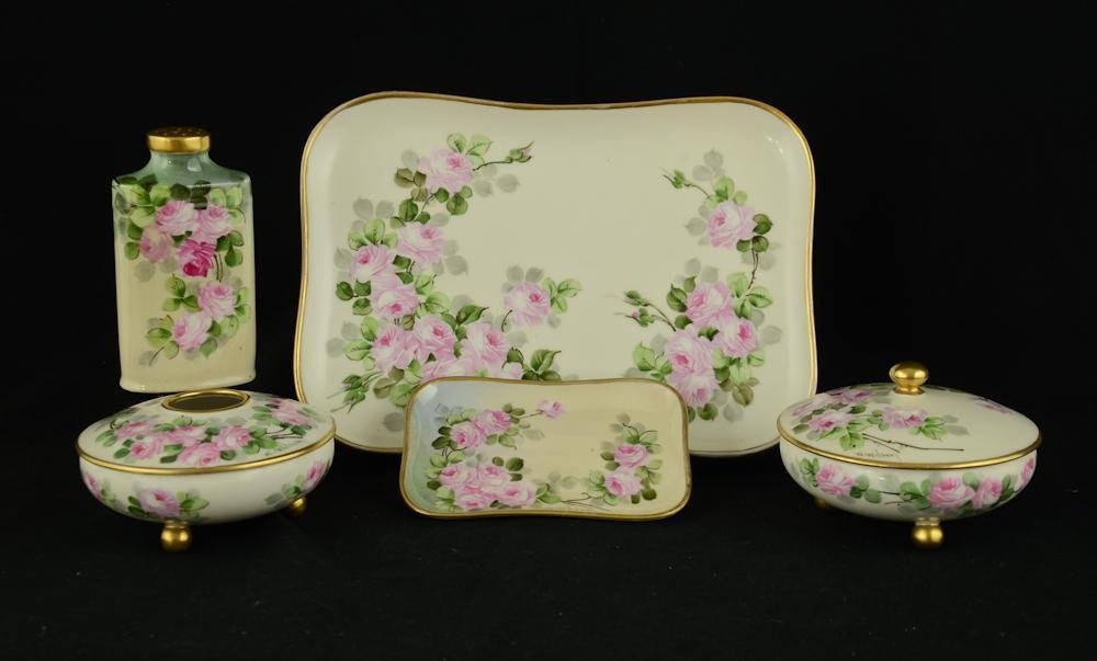 Walter Wilson Porcelain Dresser set: five pieces including powders, hair receiver, and two trays, in a rose vine pattern, signed W. Wilson. Excellent condition. The tray being 9.5" x 7".