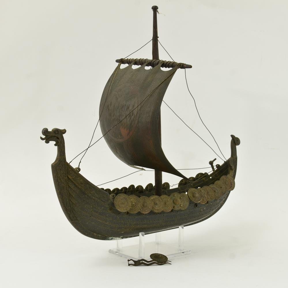 Iron Art Co. Bronzed Model Viking Ship: Highly detailed model Viking Sailing ship from Copenhagen Denmark, 20th Century. Rudder broken, center mast banner separated but present. some whitish patina. 16" long, 14" tall. overall goo