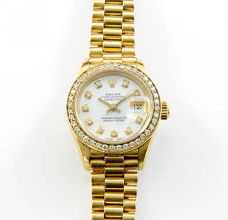 Ladies 18K Diamond Rolex Watch: Oyster perpetual Datejust, automatic, in running condition. Sometimes referred to as the Presidential. With a pink mother of pearl face and full diamond bezel ringing the face along with one diamond