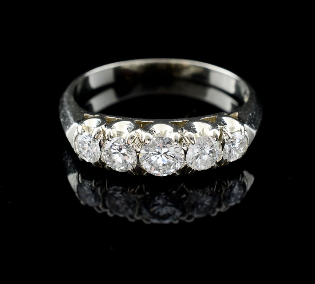 Ladies 14K Diamond Wedding Band: 14K white gold ring with 5 round brilliant diamonds with approximately 1 CTW. Size 8 One diamond is chipped from the side the tip on the underside.