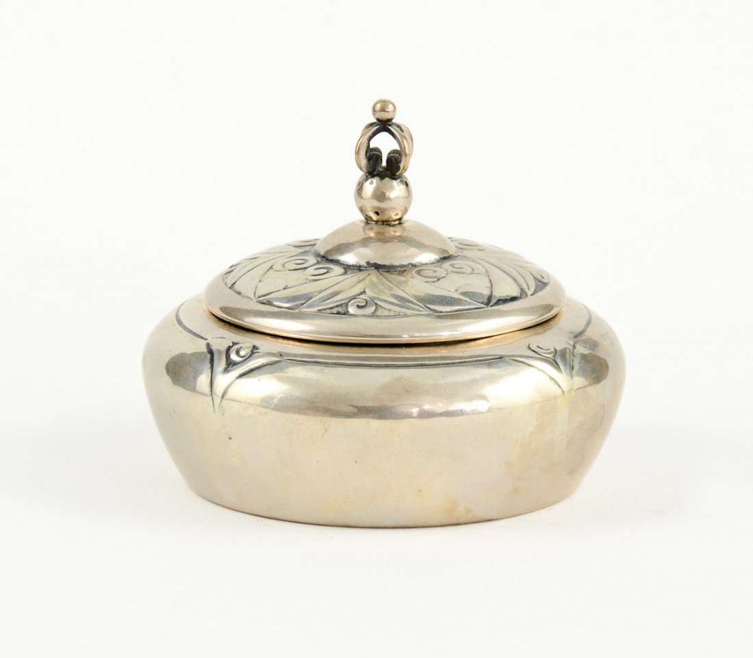 Danish Silver Round Box: A round silver box with a decorative handle and an abstracted floral motif. On the bottom is stamped 830 S, Erik M. and an EM marking. Good condition. Measures 3"h x 3 1/2"w and has a total weight of