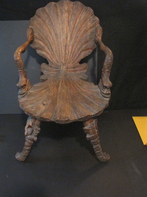 Italian grotto chair: Well carved with dolphin handles and shell carved back and seat