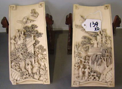 PAIR OF ANTIQUE CARVED IVORY PLAQUES: Each being approximately 8" long x 4" wide, carved right from the tusk, of 2 village scenes, with original stands, one has 2 minor flakes,INFORMATION UPDATE ...WE HAVE BEEN INFORMED THESE PLAQUES DATE