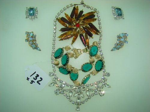 MIXED RHINESTONE COSTUME JEWELRY LOT: This 5pc lot consists of; one beautiful necklace, one purple & amber colored pin, two pairs of light blue clip earrings, and one green and gold colored double bracelet, shipping fee will be added to i