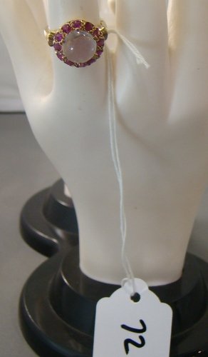 RUBY WHITE MOONSTONE & 14KT GOLD RING: 2ct white moonstone center stone, with approx 1 1/2ct of rubies, in 14kt y.g. setting, shipping fee to be added to invoice.