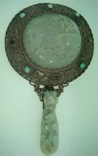 19TH CENTURY JADE & SILVER ORIENTAL HAND MIRROR: Circa 1830's, Gold washed Silver design, approx. 8" long, 6" in diameter, fabulous carved Jade insert & carved Jade Dragon handle, jeweled around the back of mirror with remnants of an old Christie's