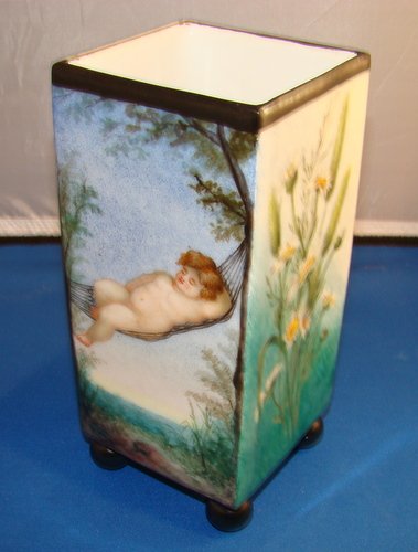 ANTIQUE FRENCH LIMOGES HAND PAINTED FOOTED VASE: Approx. 9" tall, each panel is hand painted, three panels in floral motif, the other with a baby in a hammock, artist signed to base and dated 1879, buyer arranges shipping, we can recommend local shi