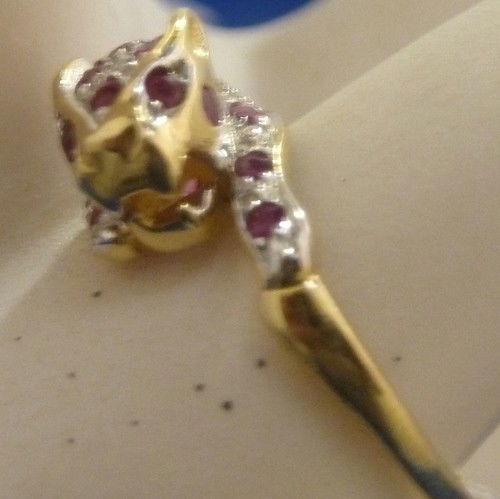 CARTIER STYLE RUBY & DIAMOND LEOPARD RING: CARTIER STYLE RUBY & DIAMOND LEOPARD RING size 7; with approx .30 cts of rubies; .40 cts of diamonds on 14kt yellow gold We can recommend local shippers