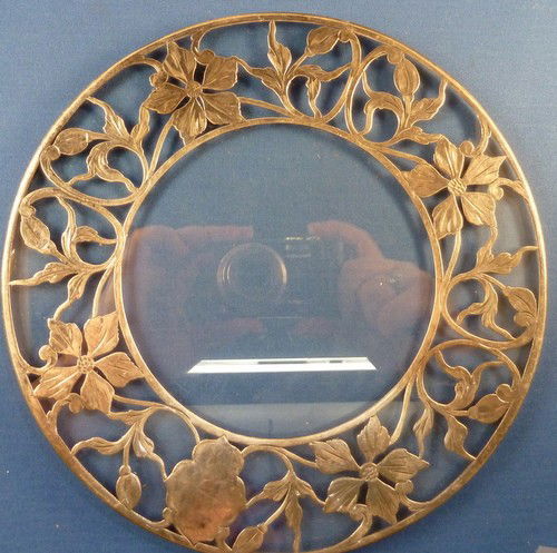VINTAGE STERLING OVERLAY TRIVET: VINTAGE STERLING OVERLAY TRIVET approx. 8" diameter with floral silver overlay; no breaks We can recommend local shippers