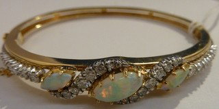 BEAUTIFUL LADIES OPAL AND DIAMOND BANGLE: BEAUTIFUL LADIES OPAL AND DIAMOND BANGLE with aprox 1ct of diamonds, and 3 fabulous opals on 14kt yg