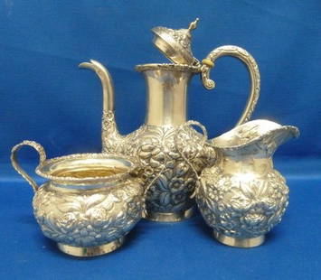 3 PIECE STERLING REPOSE TEA SET: 3 PIECE STERLING REPOSE TEA SET Baltimore Rose pattern;teapot approx 7.5" tall;accompanied with creamer and sugar;handle held with ivory fasteners;approx 18 ounces we can recommend local shippers