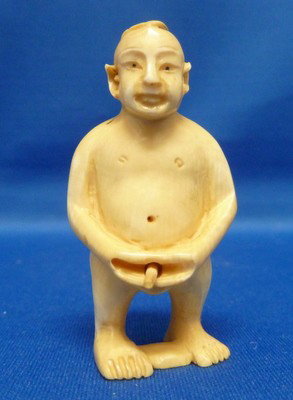 ANTIQUE IVORY EROTIC NETSUKE: ANTIQUE IVORY EROTIC NETSUKE approx 2" tall;a naked man holding his movable member we can recommend local shippers