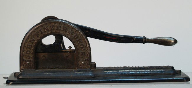 Early Countertop Cast-Iron Plug Tobacco Cutter: Early Countertop Cast-Iron Plug Tobacco Cutter by John Finzer & Bro's Louisville, KY. on wood hanging base