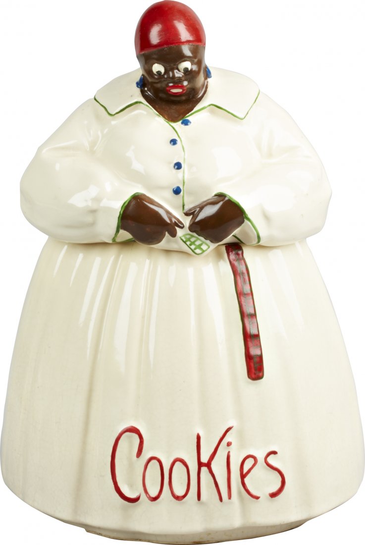Black Americana Mccoy Pottery "Mammy" Ceramic Cookie Ja: Black Americana McCoy Pottery "Mammy" Ceramic Cookie Jar, marked "McCoy" on bottom and "Cookies" on front, c1940s-50s. Small hairline crack at top of skirt, some crazing