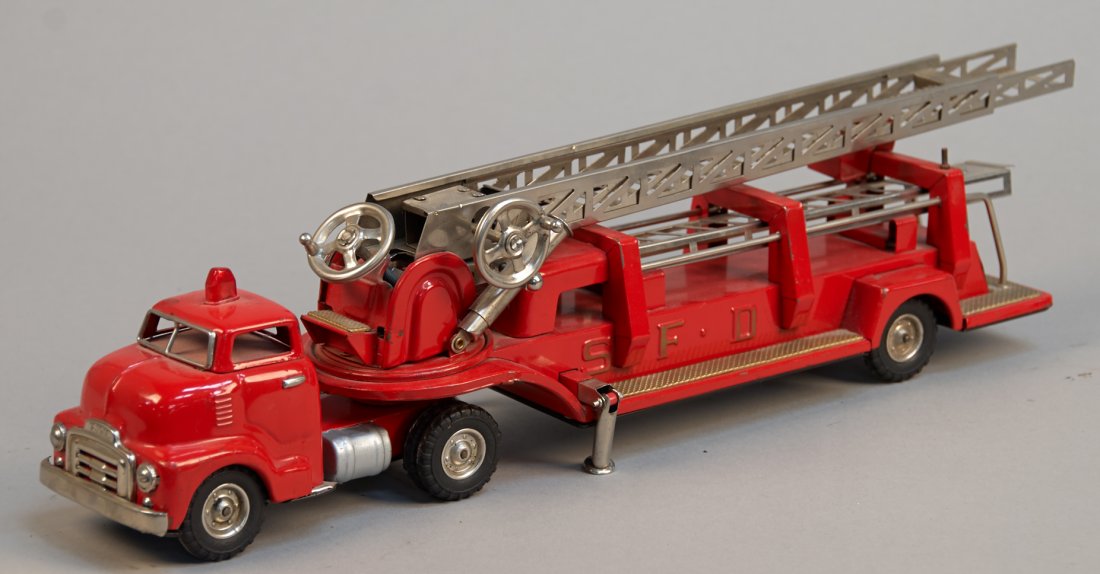 "S.F.D. Aerial Extension Ladder GMC Fire Truck": S.F.D. Aerial Extension Ladder GMC Fire Truck, Made In Japan c1960s, metal, friction - 21"l. Comes w/ an additional ladder segment, cab and trailer disconnect, in great condition