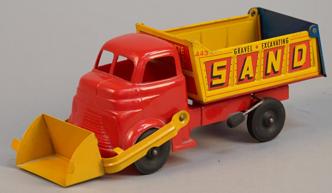 Wyandotte Sand Gravel 443 Tin Dump Truck: Wyandotte Sand Gravel 443 Tin Dump Truck Wyandotte Toys, U.S.A. The dump bed, rear hatch and front scoop are operational on this tin metal with plastic cabover body construction truck. "Sand gravel Ex