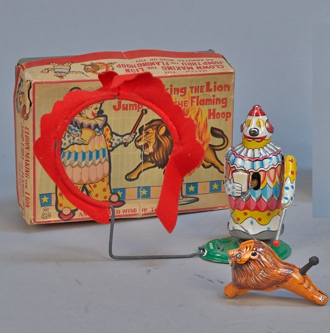Mechanical Clown Making The Lion Jump Thru The Flaming: Mechanical Clown Making The Lion Jump Thru The Flaming Hoop, T.P.S., Japan c1960, litho. tin, felt flames, rubber lion tail, wind-up - 7-1/2"h. Lion jumps through flaming hoop held by clown, in great 