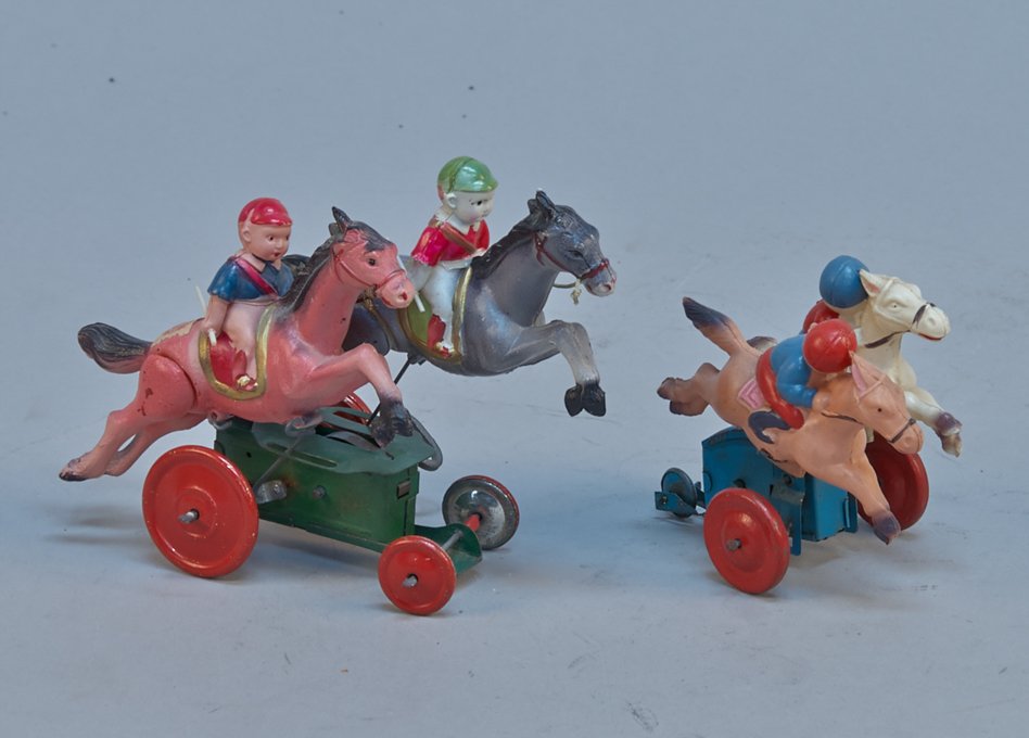 Lot Of 2 - Vintage Celluloid Wind-Up Horse Race Toys,: Lot Of 2 - Vintage Celluloid Wind-Up Horse Race Toys, Made In Occupied Japan c1945-1952 - 4"l. & 7"l., each toy has 2 horses & jockeys, on tin base w/ wheels, the horses move back & forth as the toy m