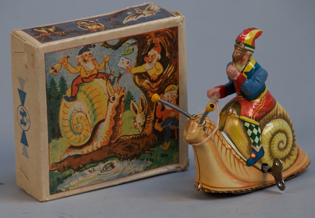 Gnome Holding Bell Riding Snail: Gnome Holding Bell Riding Snail, D.G.M., US-Zone Germany c1945-1952, litho. tin, wind-up - 5"h. In great condition, small repair to arm w/ O.B.