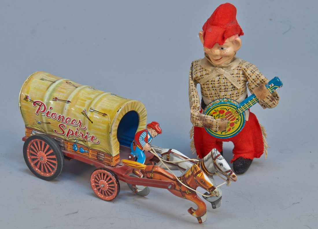 Lot Of 2 - Vintage Misc. Made In Japan Cowboy/Western T: Lot Of 2 - Vintage Misc. Made In Japan Cowboy/Western Toys c1950s: 1 - Pioneer Spirit covered wagon, litho. tin, friction - 7"l. & 1 - cowboy playing banjo, litho. tin, celluloid, fabric, wind-up - 9-