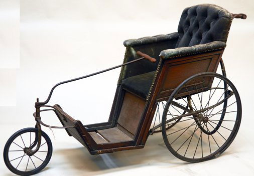 Antique English John Ward Carriage Wheelchair: Antique English John Ward Carriage Wheelchair c1850, Wood & steel frame w/ velvet button-tufted fabric cushion seat & 3 wheels, Handle for manual steering & handle for pushing, Has John Ward paper lab