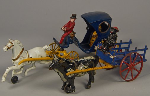 Lot of 2 - Vintage Misc. Cast-Iron & Pressed-Steel Sing: Lot of 2 - Vintage Misc. Cast-Iron & Pressed-Steel Single Animal-Drawn Carriages: 1 - oxen & stake side plantation cart w/ black driver - 13"l. & 1 - Victoria Cab w/ driver (broken leg) & fancy lady r