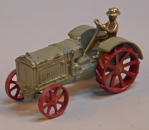 Lot of 2 - Early Arcade Cast-Iron McCormick-Deering Ite: Lot of 2 - Early Arcade Cast-Iron McCormick-Deering Items c1925-1927: 1 - grey & red tractor w/ removable driver - approx. 7"l. & 1 - grey & red thresher - 12"l., both look to have some paint touch-up