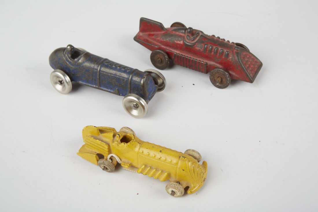 Lot of 3 - Hubley Cast-Iron Small Toy Race Cars: Lot of 3 - Hubley Cast-Iron Small Toy Race Cars w/ Attached Drivers: 1 - red w/ fin, slanted front grille, 1 - yellow w/ fin, exhaust stacks, rubber tires & 1 - blue "AUSTIN" embossed on hood, all loo