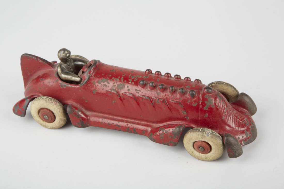 Hubley Cast-Iron Toy Race Car c1930's: Hubley Cast-Iron Toy Race Car c1930's, red, fin, exhaust stacks w/ driver & white rubber tires, wooden hubs - 8-1/2"l., looks to be in original condition