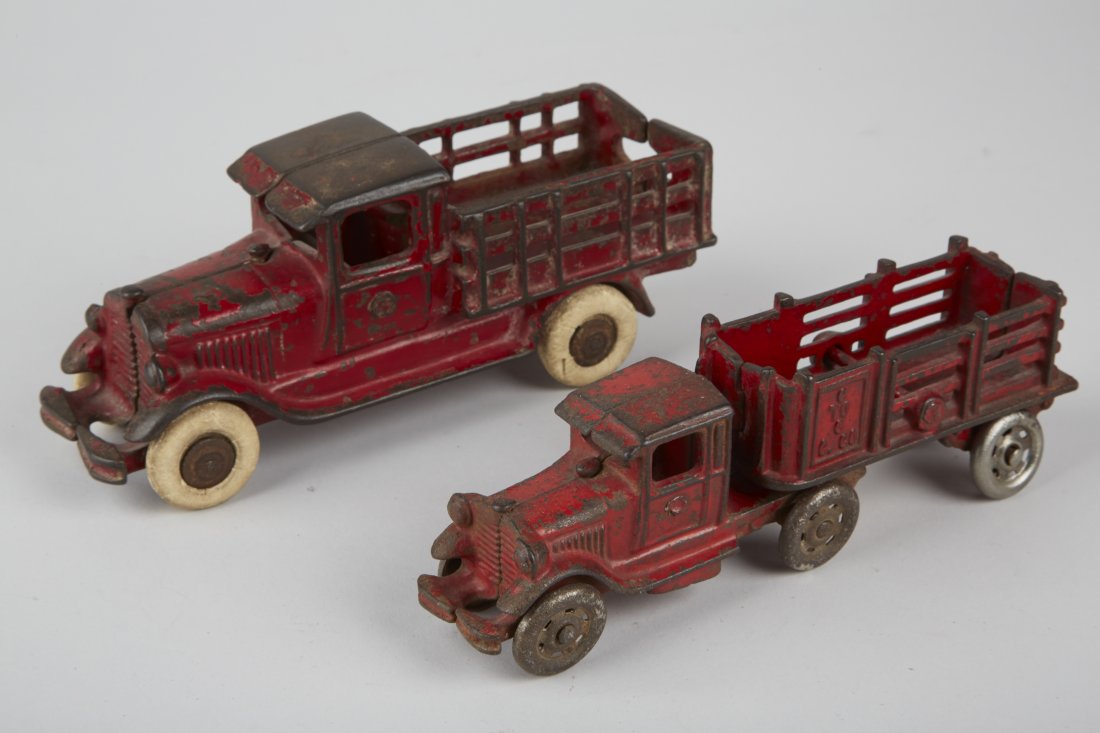 Lot of 2 - A.C. Williams Cast-Iron Mack Stake S: Lot of 2 - A.C. Williams Cast-Iron Mack Stake Style Toy Trucks: 1 - "Coast To Coast Co." (2-piece) - 7"l. & 1 - truck w/ white rubber tires - 7"l